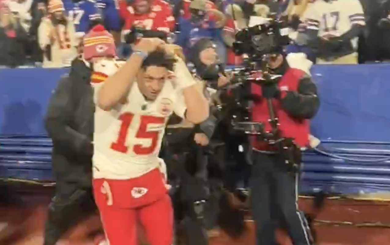 Patrick Mahomes covers his head from incoming snowballs